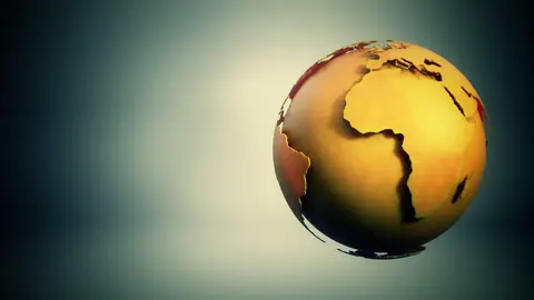 A dimensional globe spinning above a dark surface.