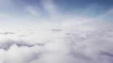 Clouds moving across an open sky.